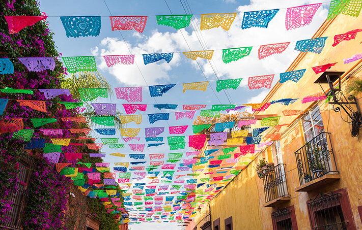 Papel picado banners are strung during celebrations